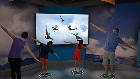 Visitors play with an exhibit in Above and Beyond.